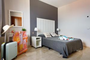 Posteľ alebo postele v izbe v ubytovaní Hotel Alguer