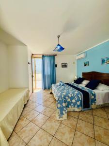 a bedroom with two beds and a window at Hotel Giglio in Lampedusa