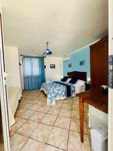 a bedroom with a bed and a table in it at Hotel Giglio in Lampedusa