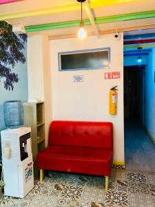 a red couch sitting in a room with a wall at Hotel Café Color in Armenia +177 photos