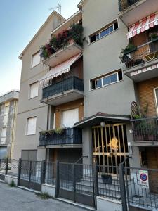a building with flowers on the balconies of it at Casa Cloe in Rimini
