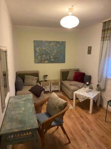 a living room with a couch and a table at Ferienwohnung 1 Klangweberei im Frankenwald in Helmbrechts