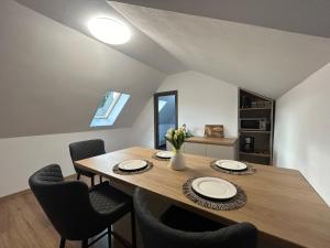 a dining room with a wooden table and chairs at Vik. Apartment in Sighişoara