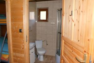 a bathroom with a toilet and a shower at Mandarynka OW in Jarosławiec +79 photos