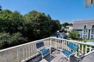 two chairs on a balcony with a view of a house at Seacastles Resort in Ogunquit