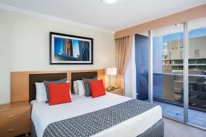 a hotel room with a bed and a television at Mantra on Mary in Brisbane