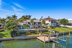 a house on the water with a dock at Peaceful Haven Waterfront Home Tierra Verde in Tierra Verde