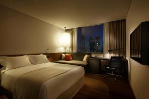 a hotel room with a bed and a desk and a chair at Shilla Stay Guro - Guro Digital Complex Station in Seoul