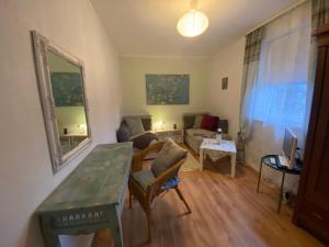 a living room with a table and a couch at Ferienwohnung 1 Klangweberei im Frankenwald in Helmbrechts