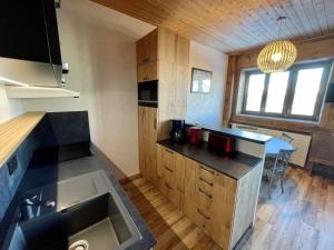 a kitchen with a sink and a counter top at T2 cabine Courchevel avec accès piste, parking et wifi - FR-1-514-22 in Courchevel