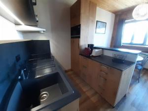 a kitchen with a sink and a counter top at T2 cabine Courchevel avec accès piste, parking et wifi - FR-1-514-22 in Courchevel +12 photos