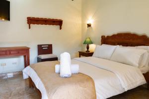 a bedroom with a bed with a towel animal on it at Hotel Beth Sarim in Villa de Leyva +34 photos