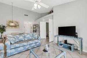 a living room with a blue couch and a tv at St Pete Isla Vista Verde E 3 219 Corner Unit 2 2 in Point Brittany