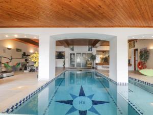 a swimming pool in a house with a wooden ceiling at Bight Boathouse in Dartmouth