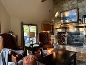 a living room with a fireplace and chairs and a table at Country Roads take me home in Terra Alta