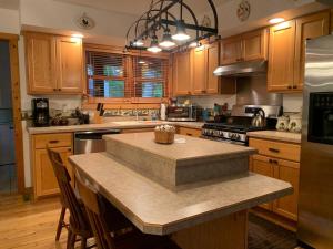 a kitchen with wooden cabinets and a island with a counter top at Antler Ridge in Terra Alta +10 photos
