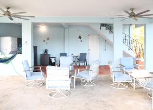 a dining room with blue chairs and a table at One Bedroom Apartment in Rincon in Rincon
