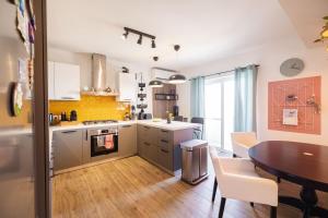 a kitchen with a table and a dining room at Rinella beach house in Birgu