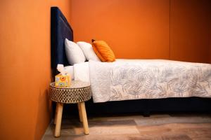 a bedroom with a bed with an orange wall at One Bedroom Apartment in Rincon in Rincon +6 photos