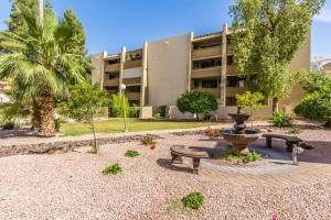 a courtyard with a fountain and benches in front of a building at Old Town Maya Condo with Community Pool and Spa in Scottsdale