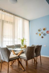a dining room with a glass table and chairs at Tirana Centre Lions Gate 3 in Tirana