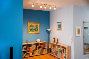 a room with blue walls and bookshelves at Tirana Centre Lions Gate 3 in Tirana