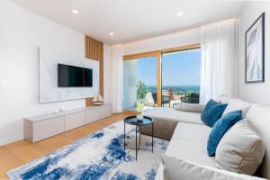 a living room with a couch and a tv at Luxury Adria Sea City & Whirpool, Mountain View Apartment in Makarska