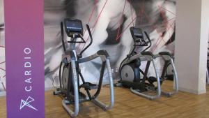 a group of three exercise bikes parked next to a wall at Marriott Jacksonville in Jacksonville