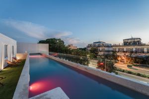 a swimming pool on the roof of a building at Hotel Chariot in Mérida