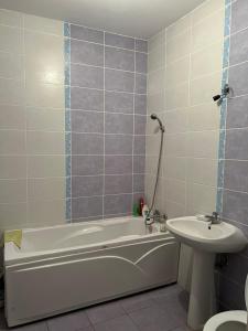 une salle de bain avec une baignoire et un lavabo dans l'établissement Apartament 1 cameră, à Bragadiru