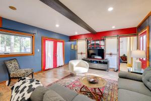 a living room with blue and red walls at Outdoor Oasis Grove Cabin Near Grand Lake in Grove