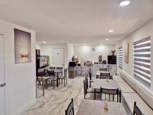 a restaurant with tables and chairs and a kitchen at Nova Inn Resort in Boynton Beach