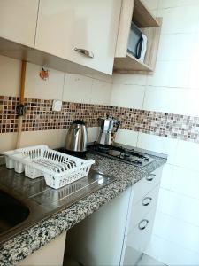 a kitchen with a sink and a counter top at Studio très haut standing avec vue dégagée in Tunis