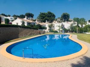 a large blue swimming pool with a shark in the middle at Casa Julia Moraira in Moraira