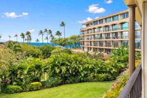 a view of a hotel with palm trees and a garden at Aston Maui Kaanapali Villas in Lahaina