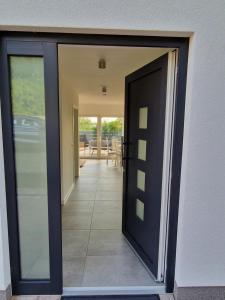 an open door of a house with a patio at Villa Lago am Plauer See in Alt Schwerin