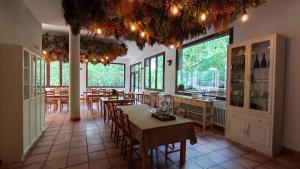 a restaurant with tables and chairs and large windows at L'indret del Pedraforca Adults Only in Saldés