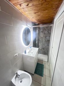 a bathroom with a sink and a toilet and a mirror at Leandra Apartment in Civitavecchia