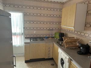 a kitchen with a sink and a stove top oven at Pisos Isla Cristina 1 in Isla Cristina