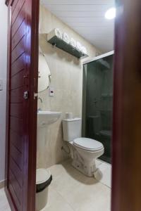 a bathroom with a toilet and a sink and a shower at Hotel Coração Verde in Alter do Chao +138 photos