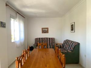 a living room with two chairs and a wooden table at Pisos Isla Cristina 2 in Isla Cristina