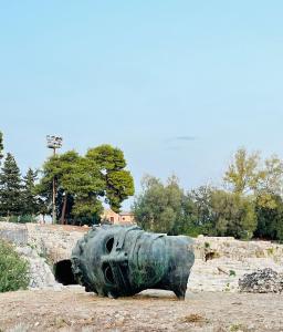 a large cannon sitting on the ground in a field at Domus Lucia in Syracuse