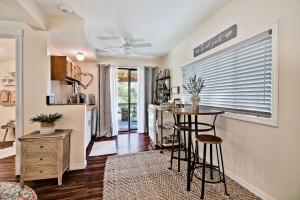 a kitchen with a table and stools in a room at Sara's Cottage in Eureka Springs