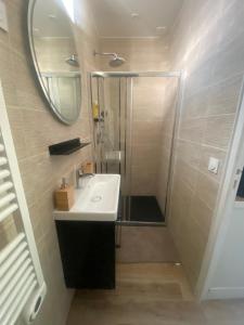 une salle de bain avec un lavabo et une douche avec un miroir dans l'établissement Chambres rénovées proches de Paris Centre, des sites olympiques, avec belle terrasse calme, à Argenteuil 42 autres photos