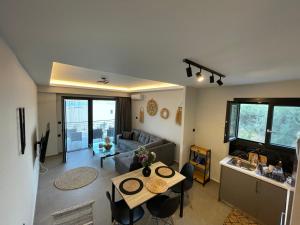 a living room with a table and a couch at sailors apartments Perigiali in Nydri
