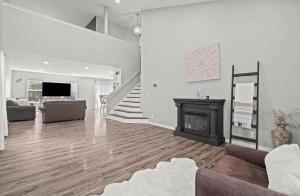 a living room with a fireplace and a staircase at 3BR Secret Gem in Phoenix
