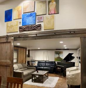 a living room with a couch and a piano at The Barn at Eagles Landing Ranch in San Luis Obispo +10 photos