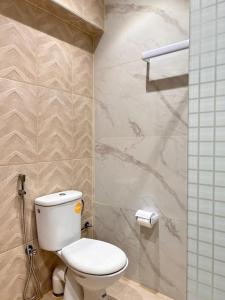 a bathroom with a white toilet and a shower at KAZA Aouchtame 1 in Tétouan +18 photos