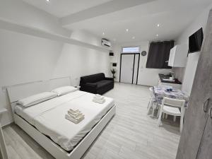a bedroom with a bed and a living room at Acquamarina in Terracina +13 photos