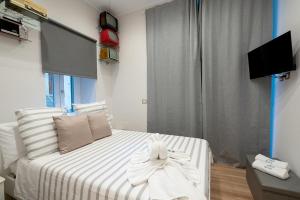 a bedroom with a bed with towels on it at Vittorio Emanuele Suite in Castellammare di Stabia